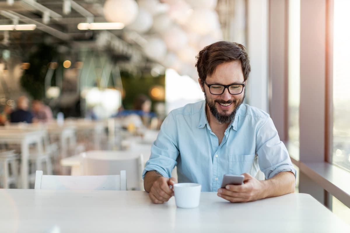 Expat in Poland using his phone to access his international bank account