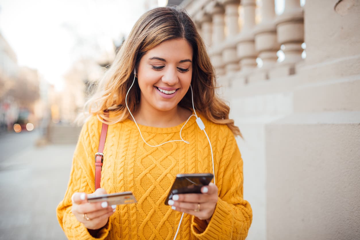 Young expat woman in Spain shopping online with her credit card