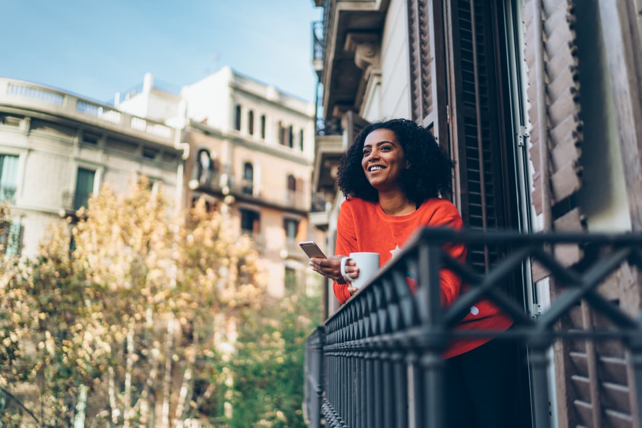 Young expat woman managing her online bank account in Barcelona, Spain