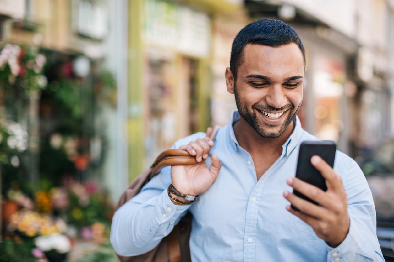 Man smiling at his phone