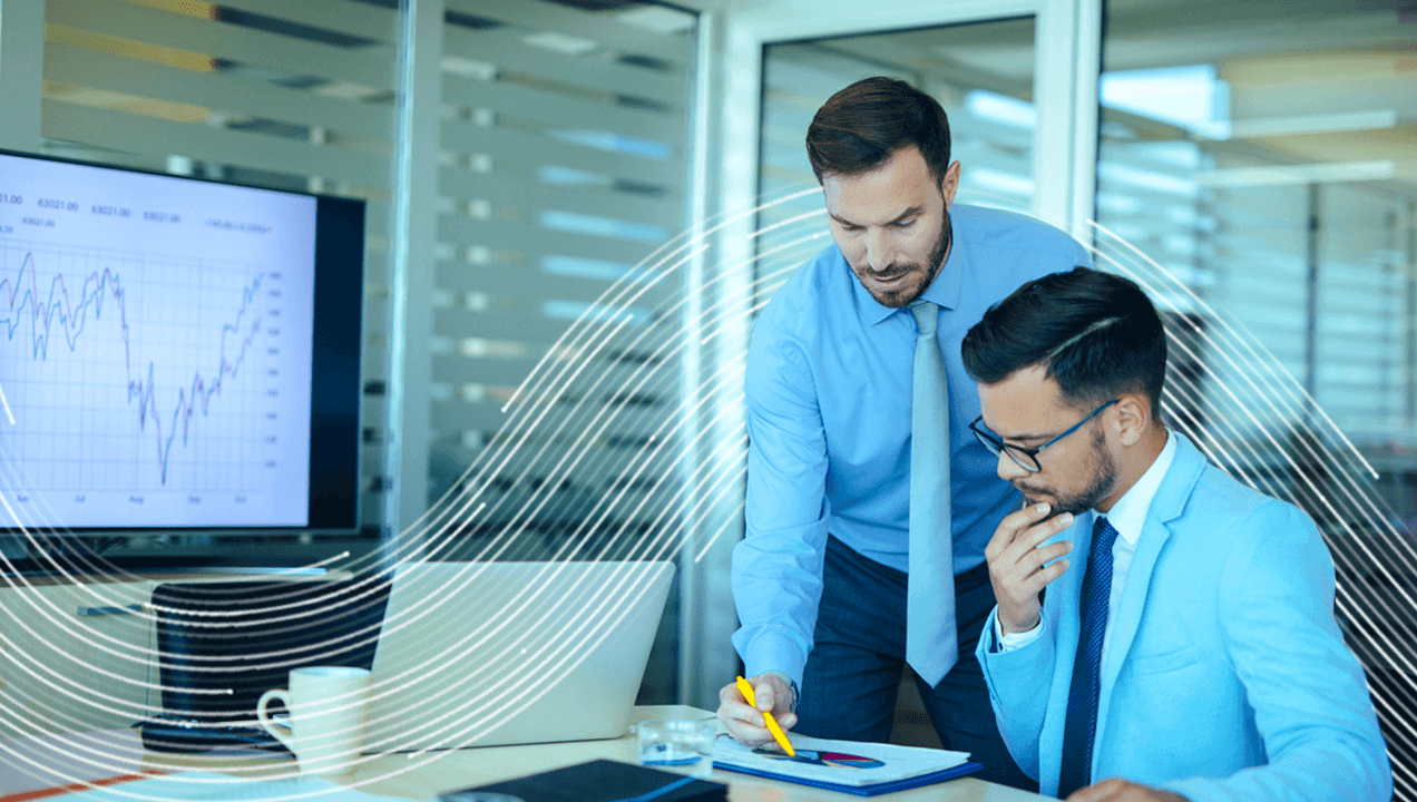 Two businessmen analyzing risk in an office.